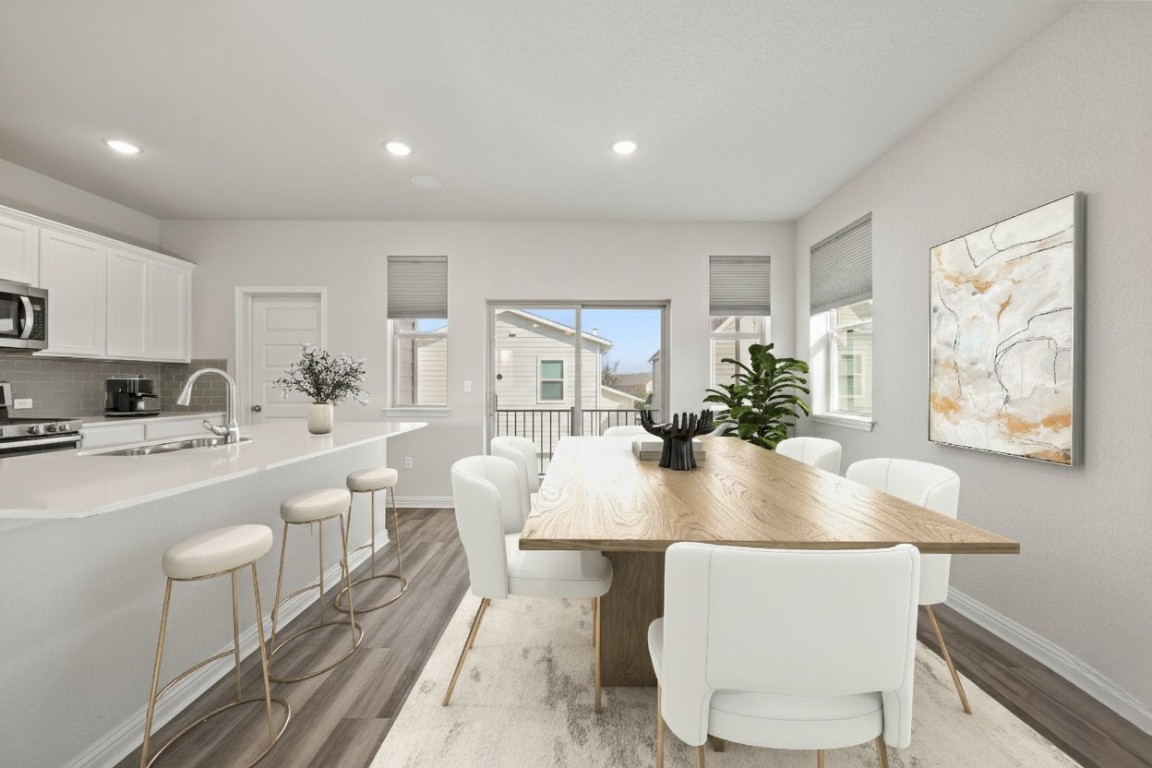 8105 Frida Bend Austin, TX 78744 - Photo 7 of 24 a view of a dining room with furniture and wooden floor