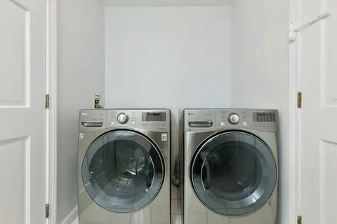 a view of a hallway with washer and dryer