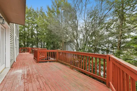 a view of deck with two chairs and wooden fence