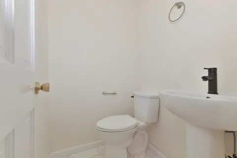 a white toilet sitting next to a bathroom sink