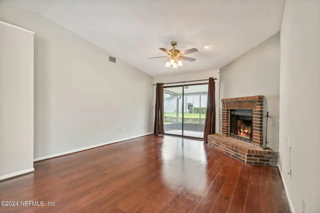 wooden floor in an empty room with a window