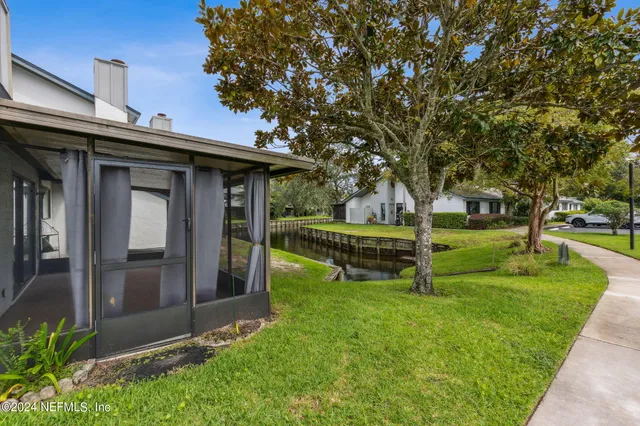 a view of a house with backyard and sitting area