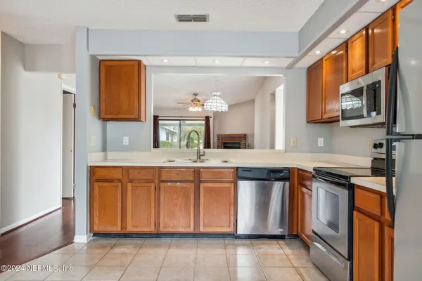 a kitchen with stainless steel appliances granite countertop a stove and a sink
