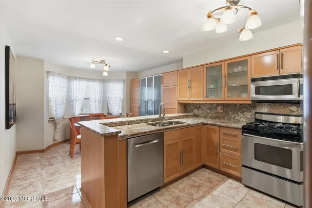 a kitchen with stainless steel appliances granite countertop a stove and a sink