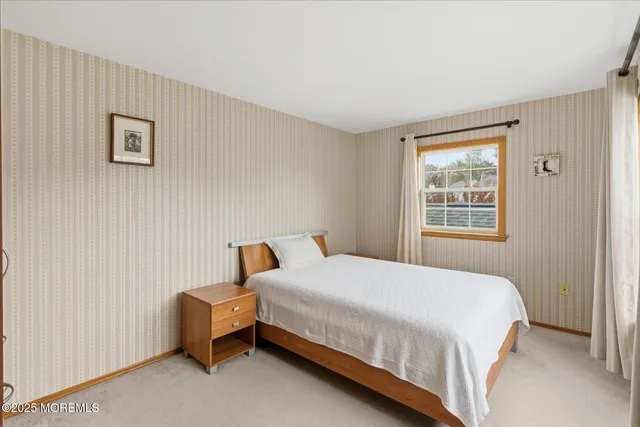 a bedroom with a large bed and closet