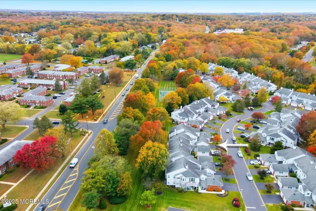 an aerial view of a house with garden space and street view