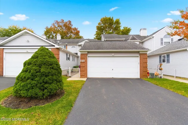 a view of a house with a yard and garage