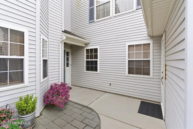 a front view of a house with potted plants