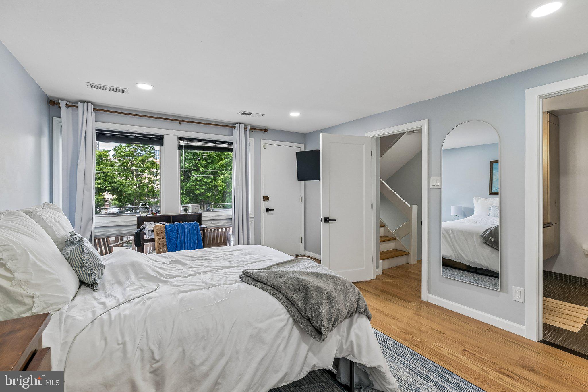 1130 Lombard Street Philadelphia, PA 19147 - Photo 13 of 45 a bedroom with a large bed and a large window
