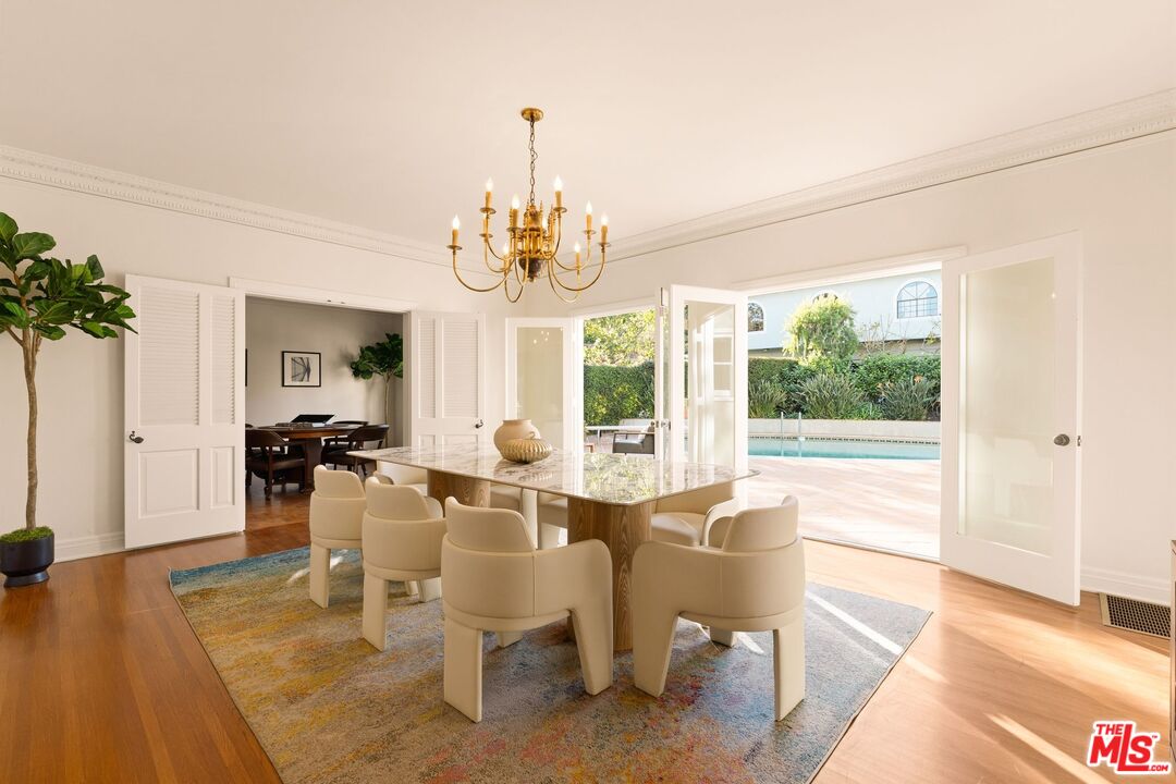441 South Muirfield Road Los Angeles, CA 90020 - Photo 14 of 33 a view of a dining room and livingroom with furniture wooden floor a chandelier