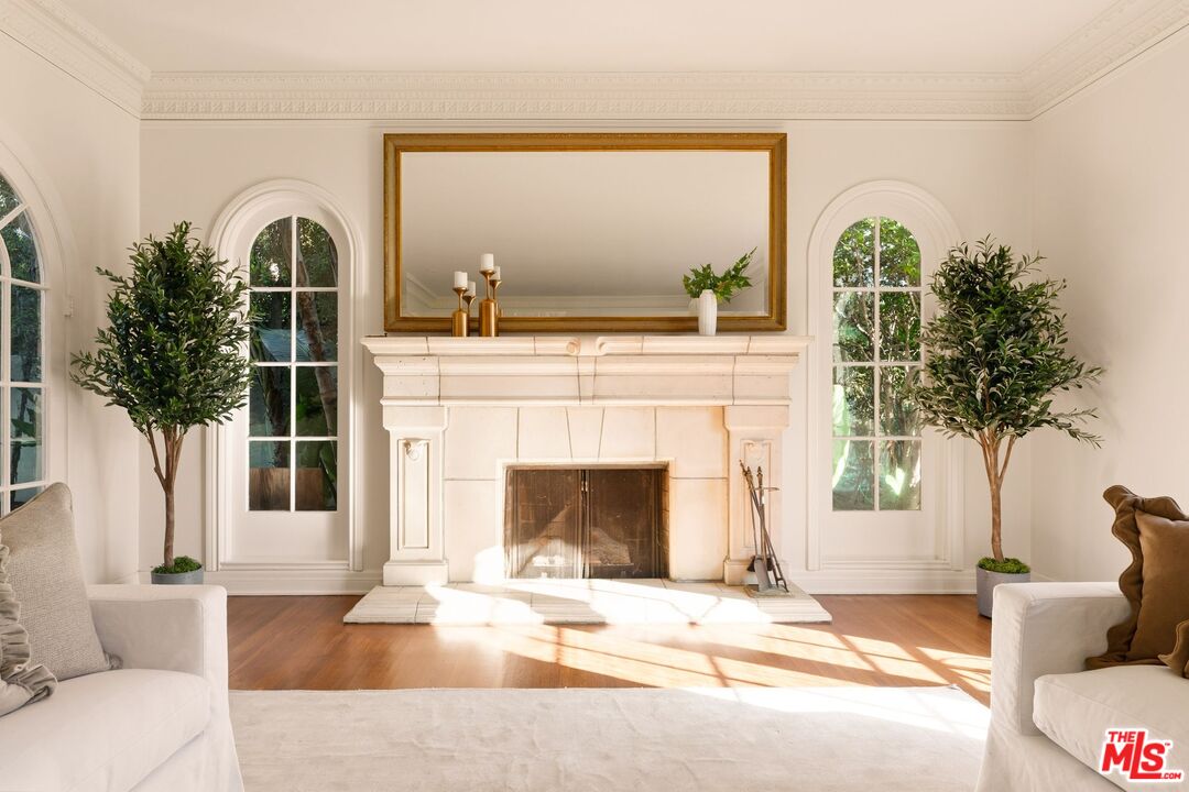 441 South Muirfield Road Los Angeles, CA 90020 - Photo 7 of 33 a living room with a fireplace and a large window