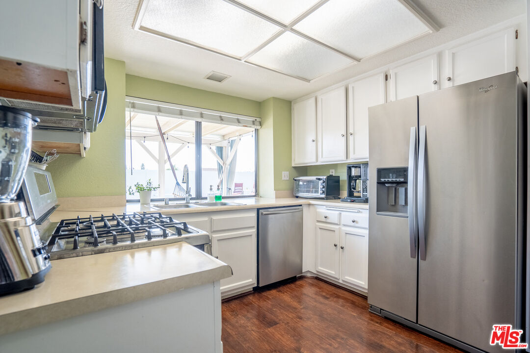 7489 Brookside Road Rancho Cucamonga, CA 91730 - Photo 12 of 41 a kitchen with a refrigerator a stove a sink and a window