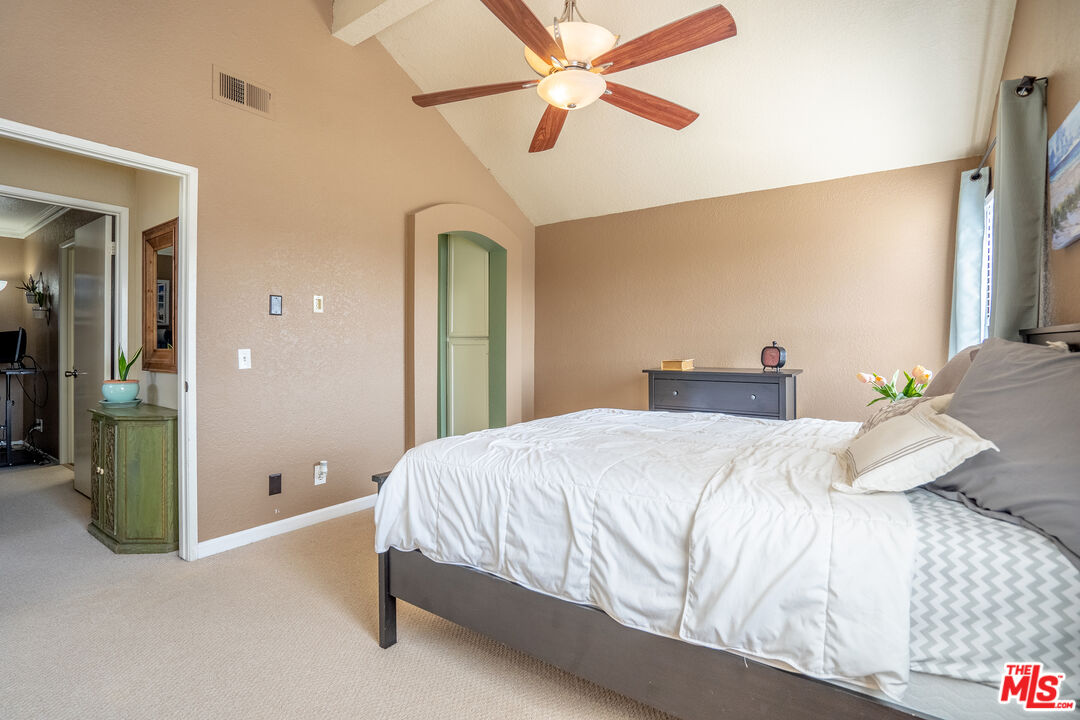 7489 Brookside Road Rancho Cucamonga, CA 91730 - Photo 21 of 41 a bedroom with a bed and a chandelier
