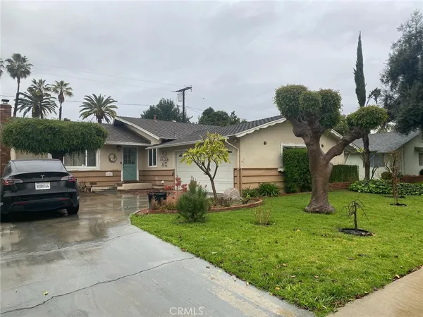 a view of a yard and front view of a house