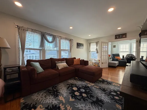 a living room with furniture window and wooden floor