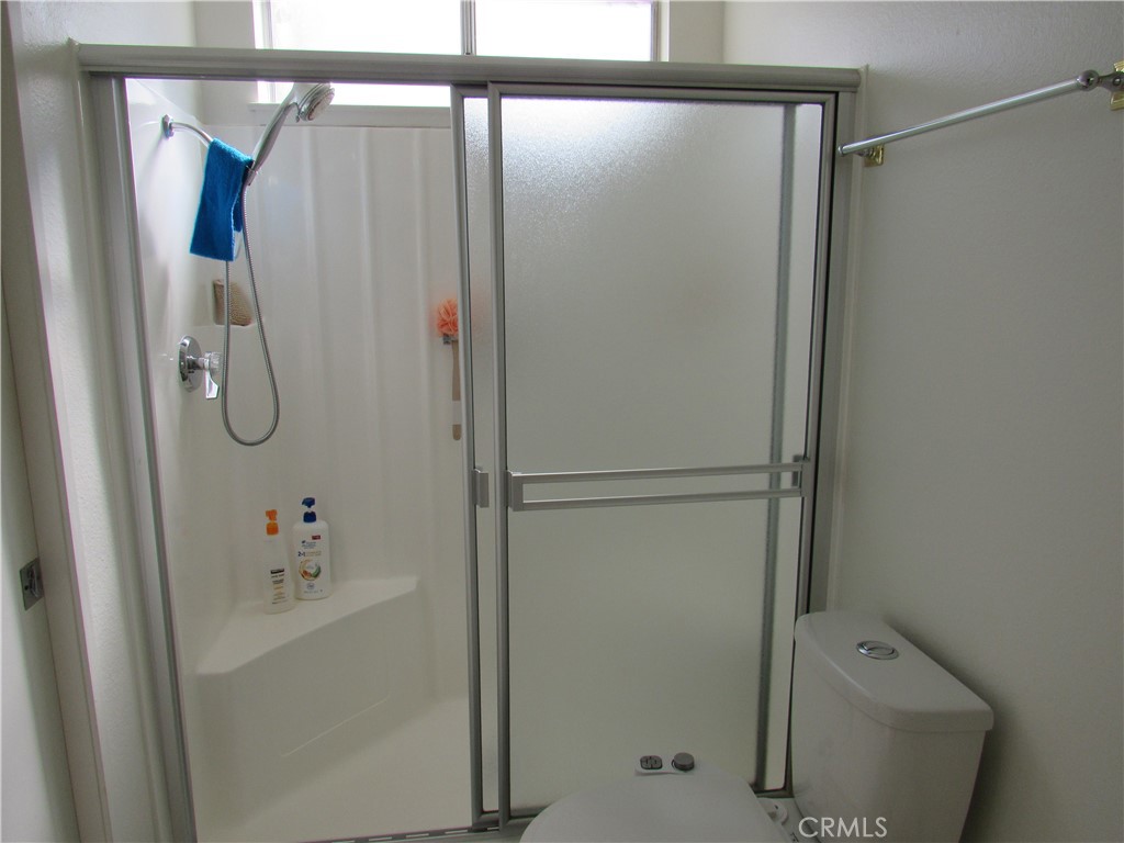 26541 Chambers Avenue Menifee, CA 92586 - Photo 19 of 61 a bathroom with a shower and a mirror