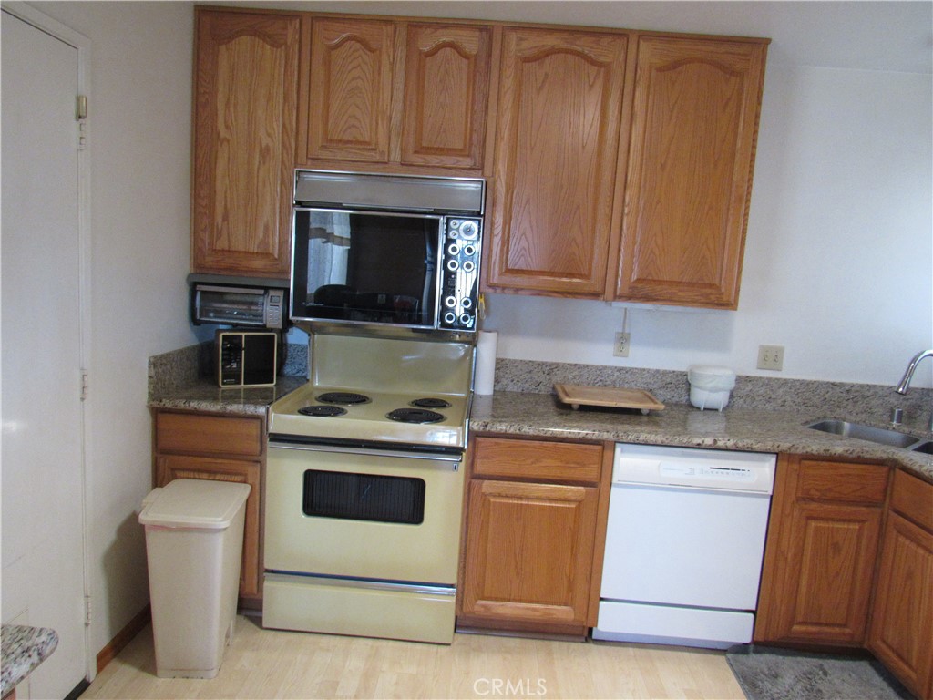 26541 Chambers Avenue Menifee, CA 92586 - Photo 32 of 61 a kitchen with granite countertop cabinets stainless steel appliances and a sink