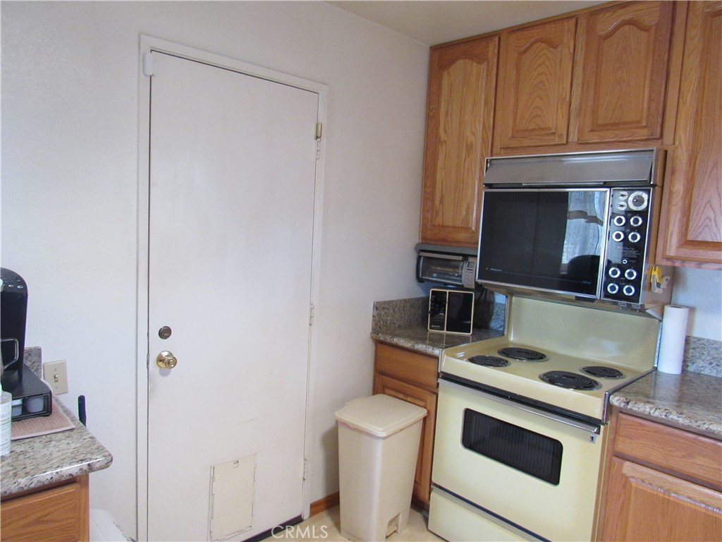 26541 Chambers Avenue Menifee, CA 92586 - Photo 33 of 61 a kitchen with a stove and a microwave