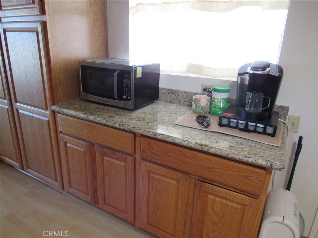 26541 Chambers Avenue Menifee, CA 92586 - Photo 39 of 61 a kitchen with cabinets and microwave