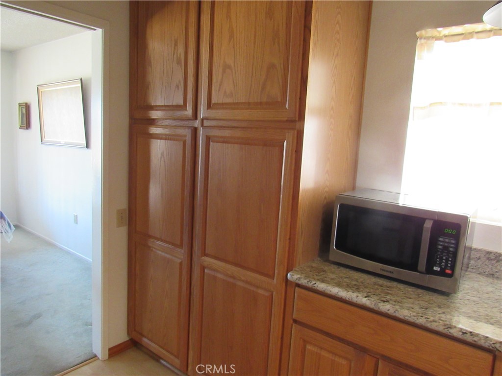 26541 Chambers Avenue Menifee, CA 92586 - Photo 40 of 61 a bathroom with a granite countertop sink and washing machine