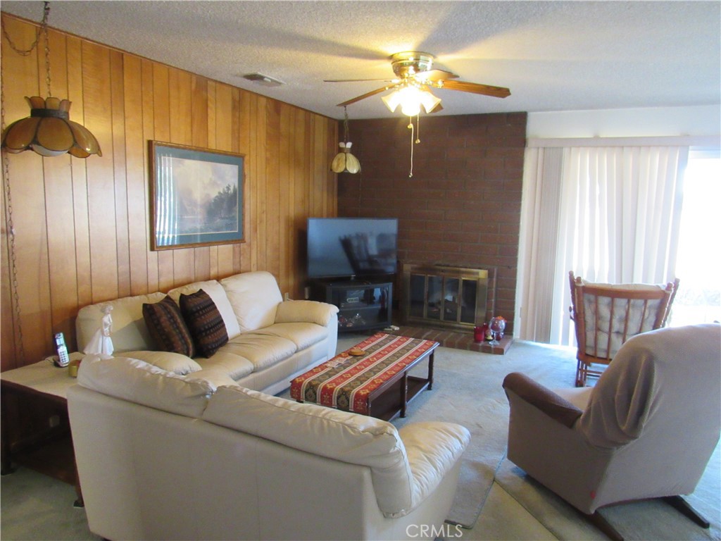 26541 Chambers Avenue Menifee, CA 92586 - Photo 4 of 61 a living room with furniture and a fireplace