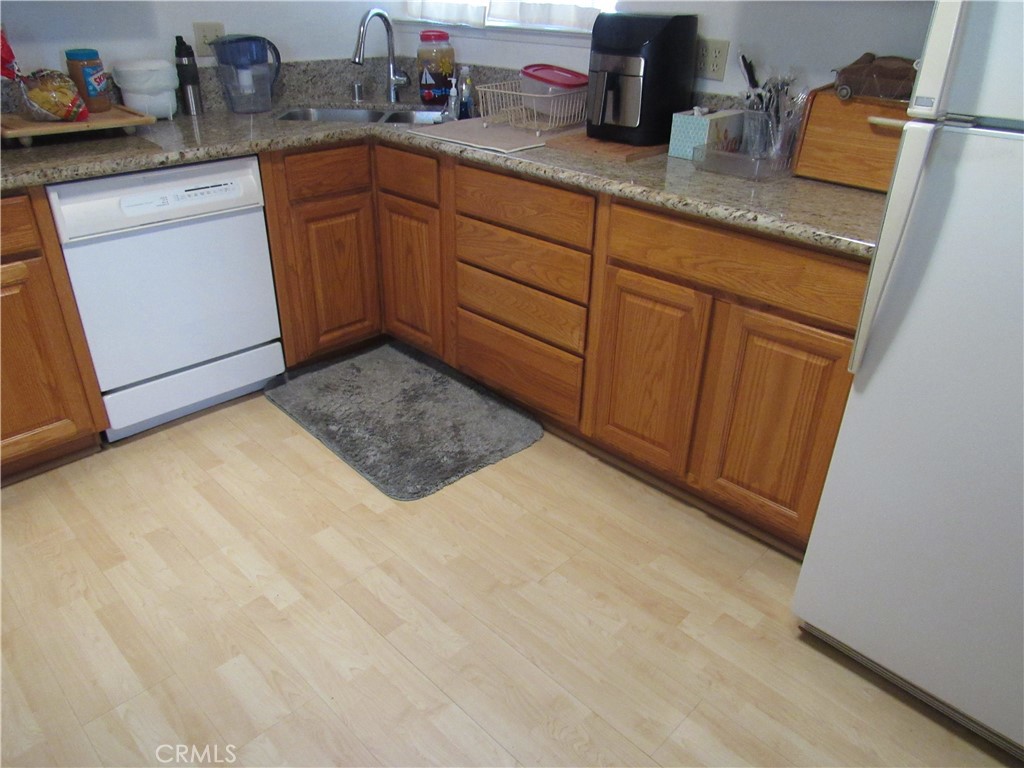 26541 Chambers Avenue Menifee, CA 92586 - Photo 42 of 61 a kitchen with granite countertop sink and cabinets