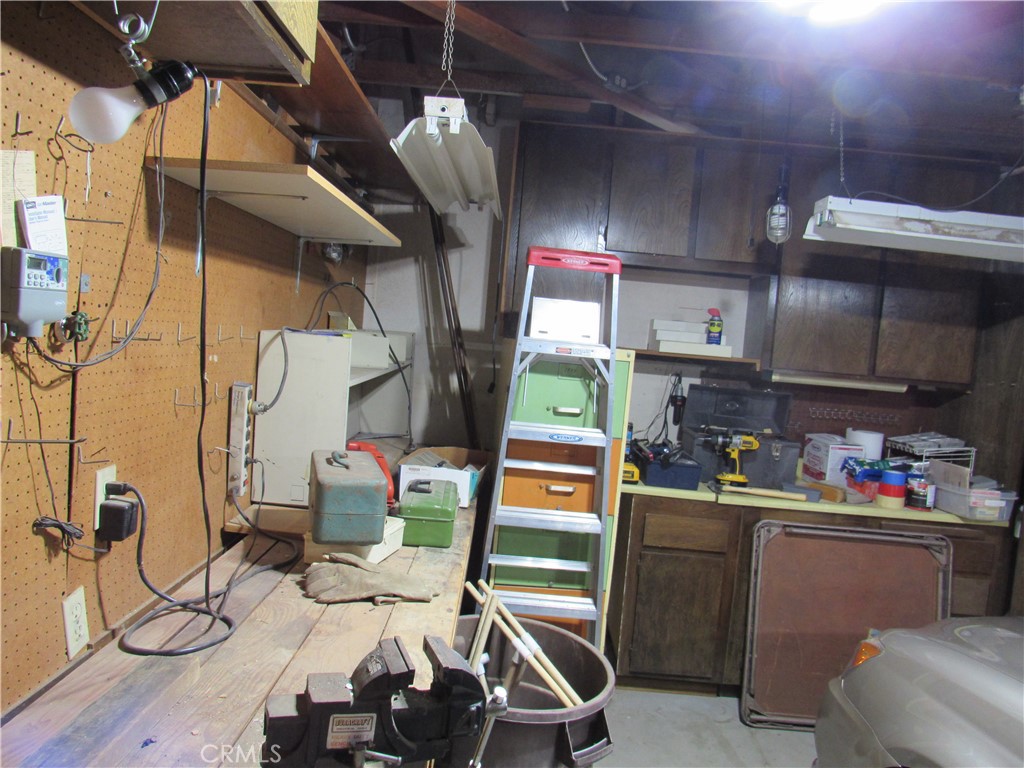 26541 Chambers Avenue Menifee, CA 92586 - Photo 53 of 61 a room with stainless steel appliances kitchen island granite countertop a sink and cabinets