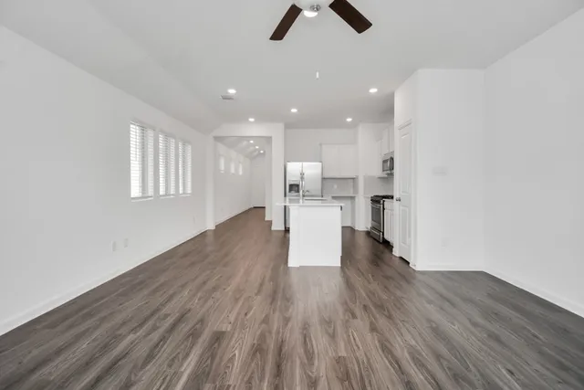 a view of kitchen with wooden floor electronic appliances and window