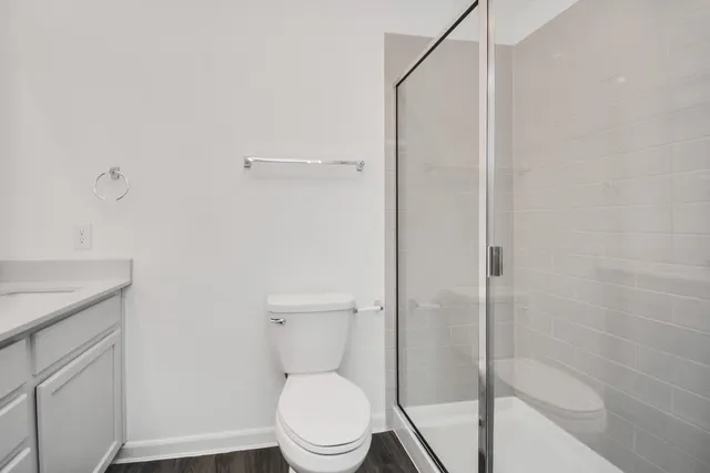 a white toilet sitting next to a bath tub