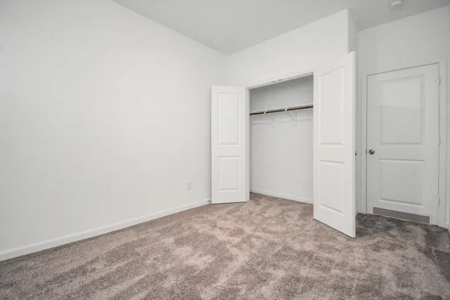 an empty room with closet area