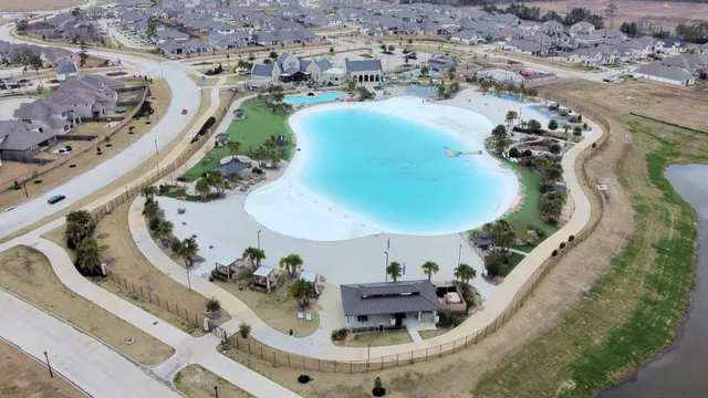 an aerial view of a swimming pool with outdoor seating