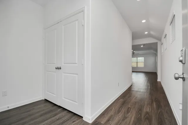 a view of a hallway with wooden floor