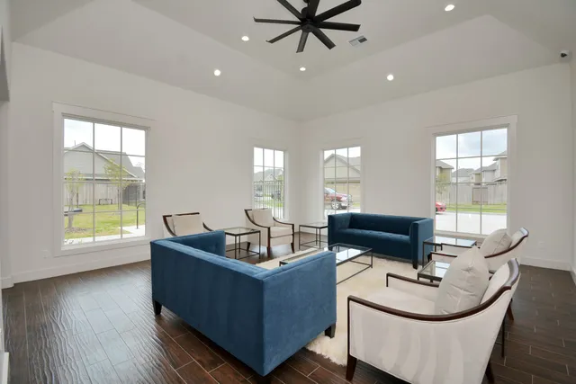 a living room with furniture and a potted plant