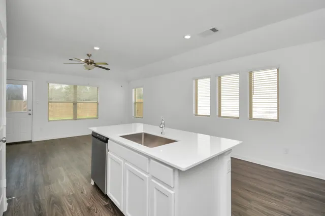 a kitchen that has a sink and a stove top oven