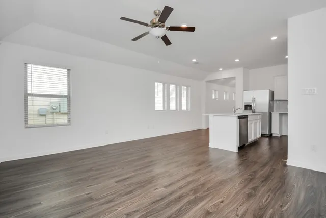 a view of a kitchen with wooden floor and a kitchen