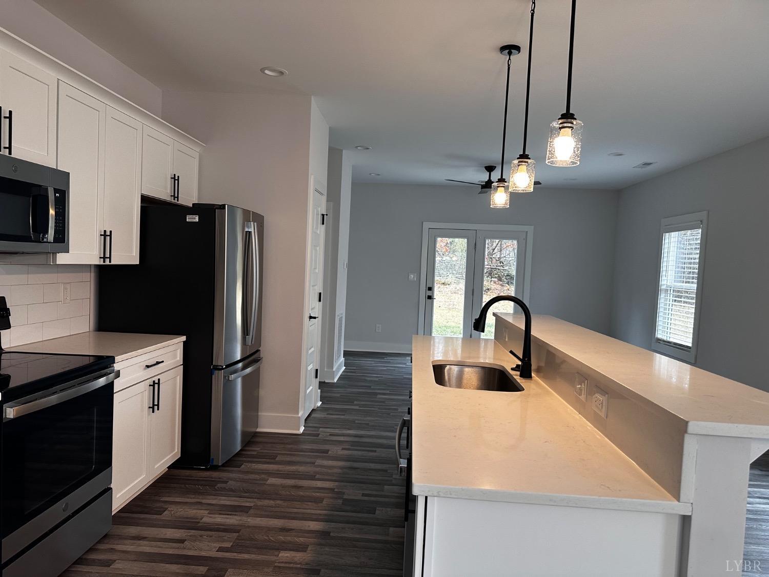 40 Allure Drive Rustburg, VA 24588 - Photo 4 of 20 a kitchen with stainless steel appliances granite countertop a refrigerator a sink dishwasher a stove and a dining table with wooden floor