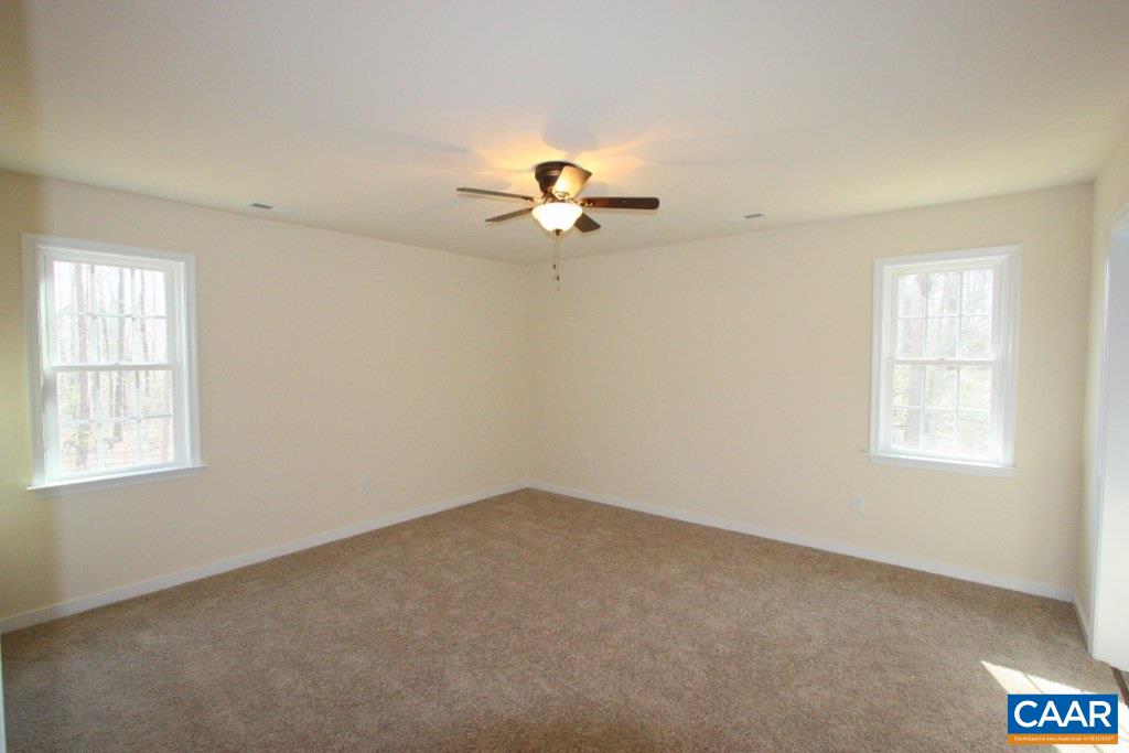 12 Winding Ridge Way Bumpass, VA 23024 - Photo 15 of 18 an empty room with a window and a ceiling fan