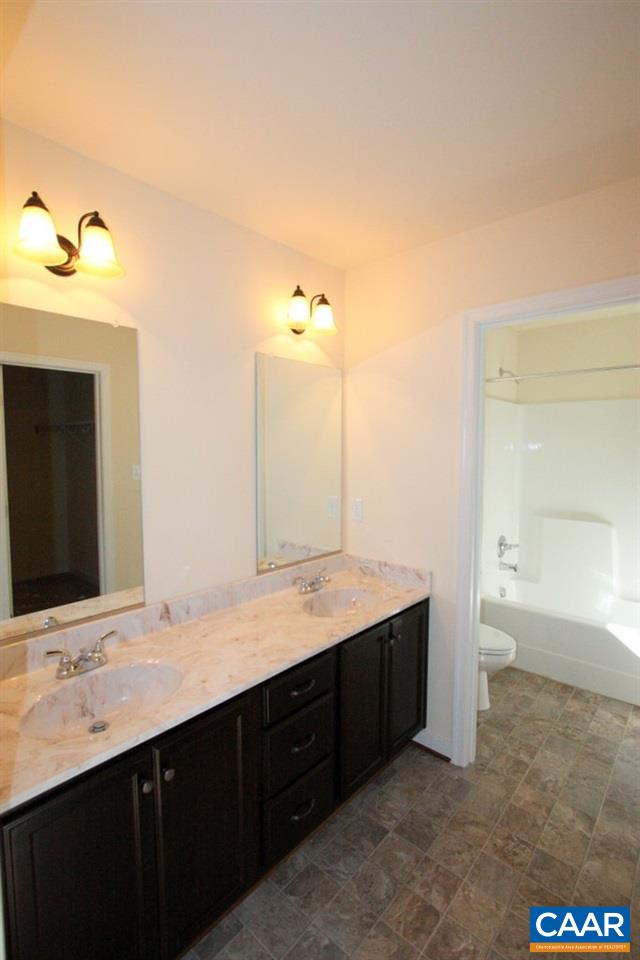 12 Winding Ridge Way Bumpass, VA 23024 - Photo 16 of 18 a bathroom with a double vanity sink and a mirror