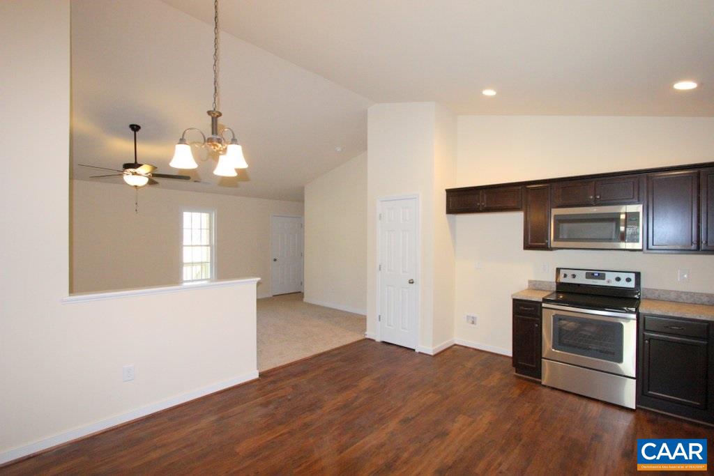 12 Winding Ridge Way Bumpass, VA 23024 - Photo 6 of 18 a kitchen with stainless steel appliances granite countertop a sink a stove a refrigerator and microwave