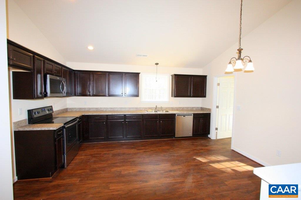 12 Winding Ridge Way Bumpass, VA 23024 - Photo 9 of 18 a large kitchen with stainless steel appliances a stove a sink and a microwave