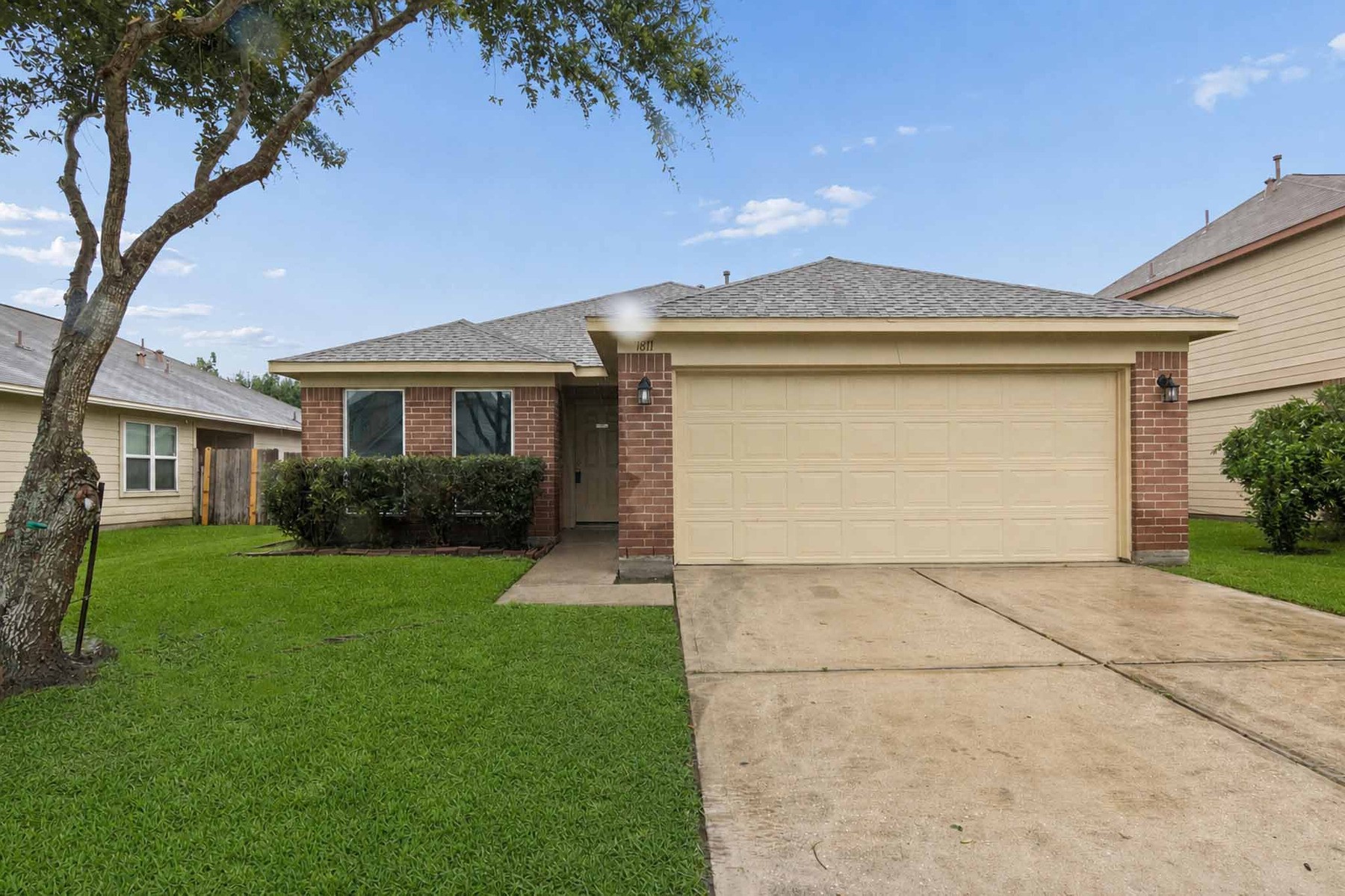 7811 Adonis Avenue Baytown, TX 77521 - Photo 3 of 36 a front view of a house with a yard and garage