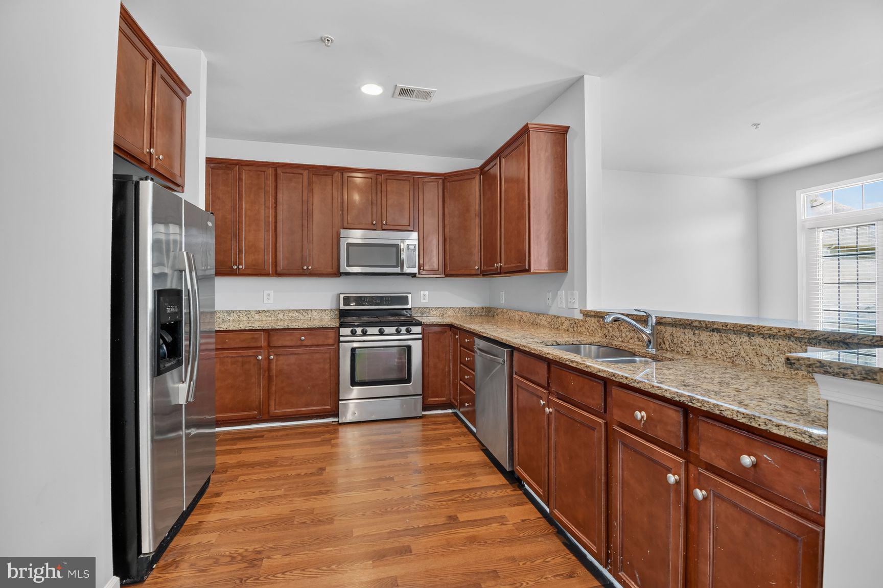 11612 Leesborough Circle Silver Spring, MD 20902 - Photo 3 of 29 Modern kitchen with rich wood accents.