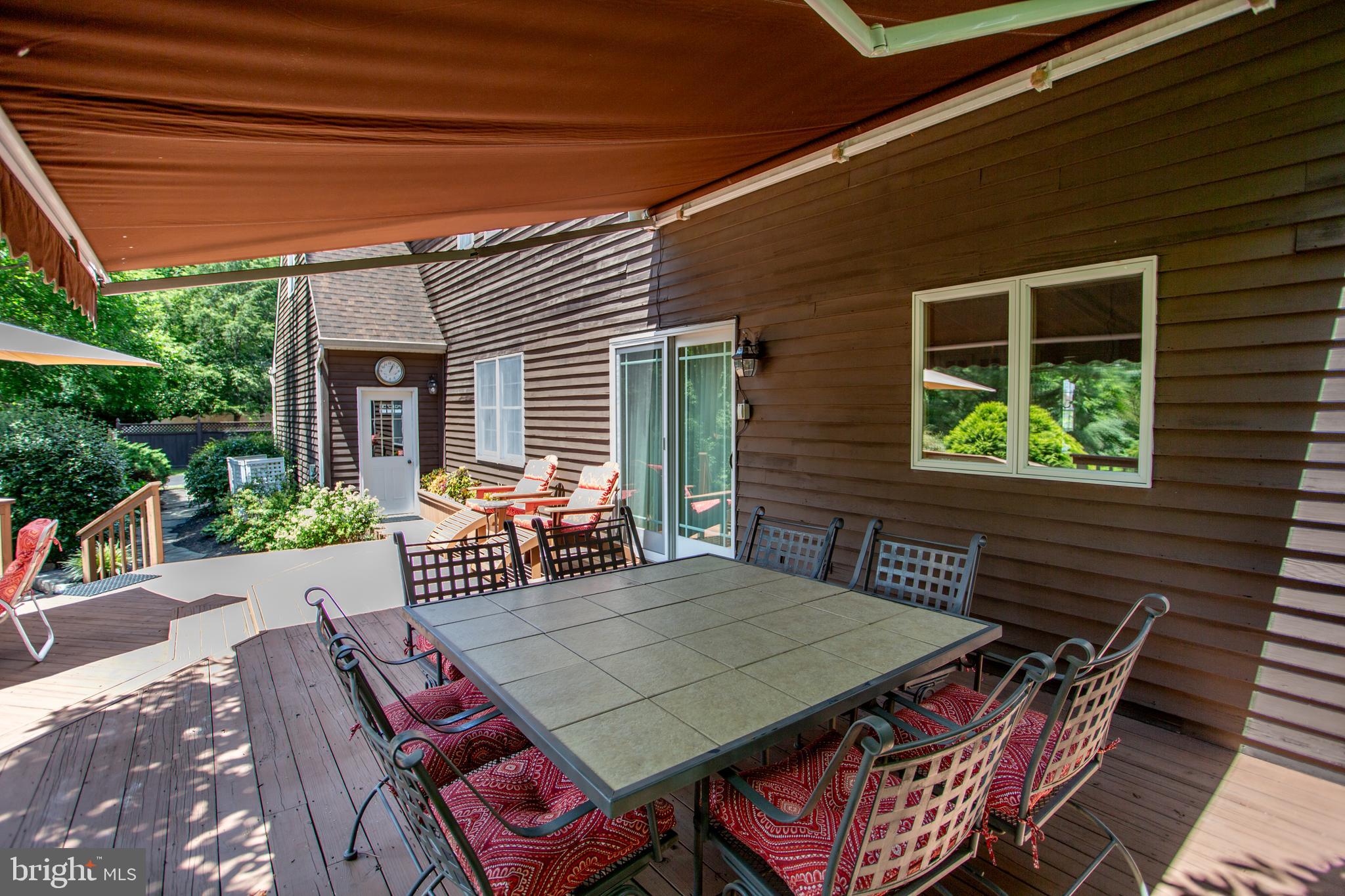 950 Camelot Road Furlong, PA 18925 - Photo 80 of 106 a view of a patio with table and chairs with wooden floor and fence