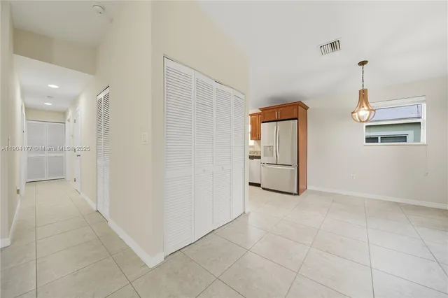 a view of an empty room and closet area