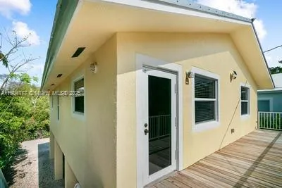a view of a house with a door and wooden floor
