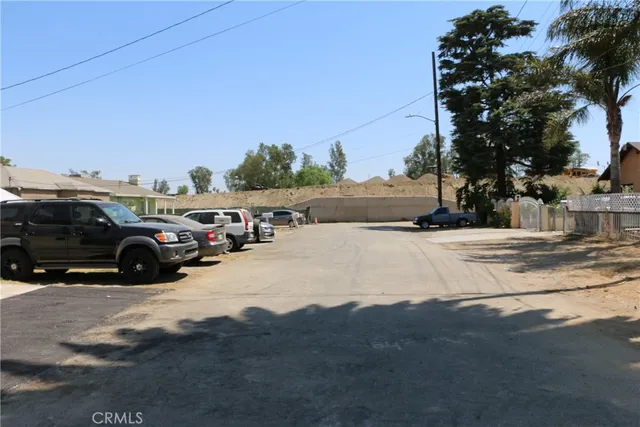 a view of a sign board with buildings in the background