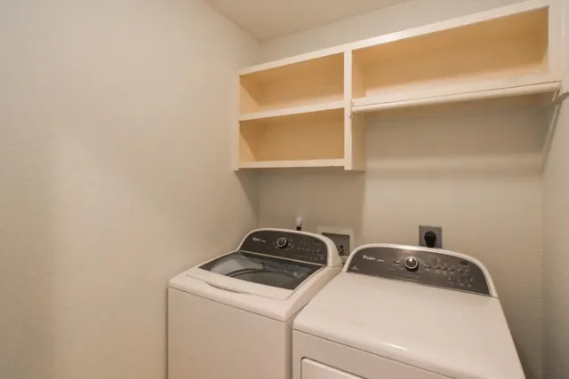 a view of room with window and a ceiling fan