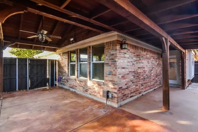 a view of a backyard with wooden fence