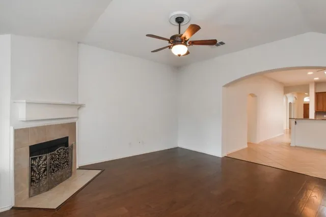 a view of empty room with windows and fireplace