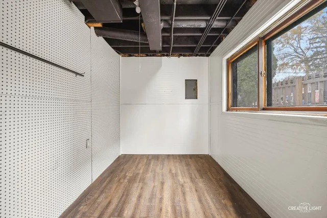 a view of a room with wooden floor and iron stairs